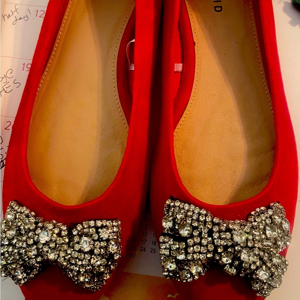 Red beautiful flats with bedazzled bow.